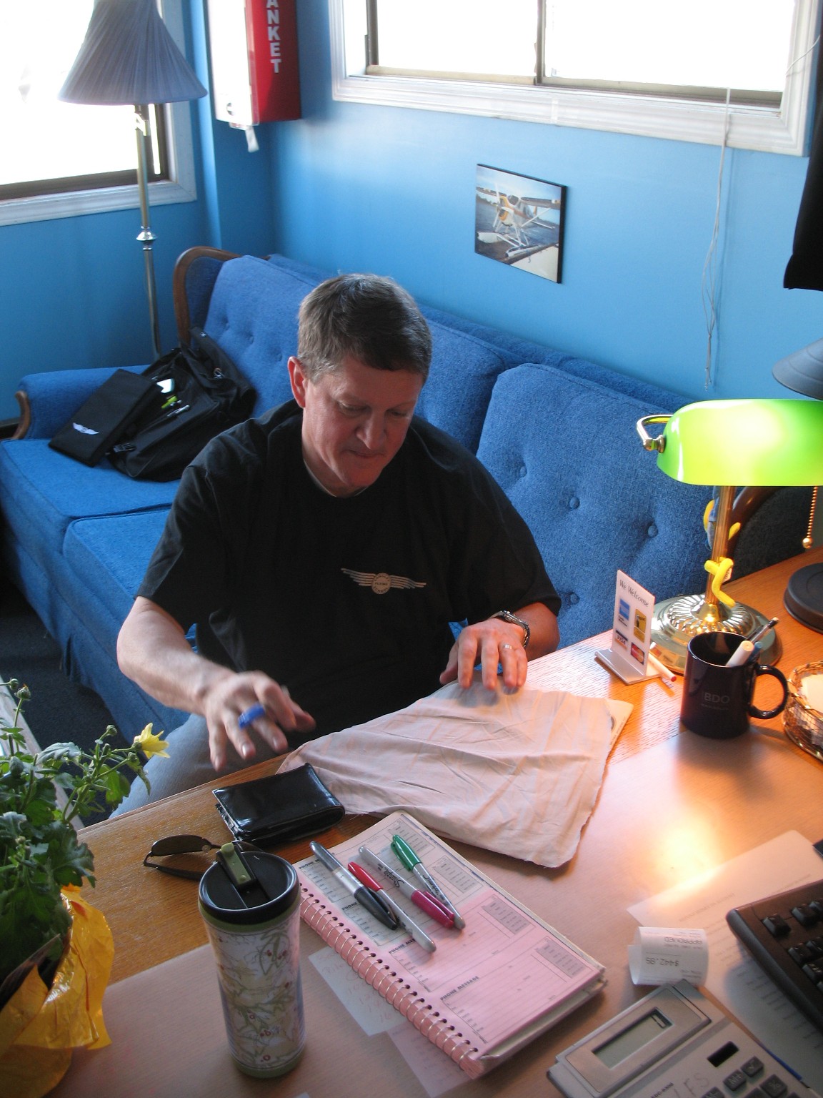 David Marshall scribes on his Solo Tag--a piece of cloth that formed part of the shirt he was wearing during his First Solo Flight.  Langley Flying School.